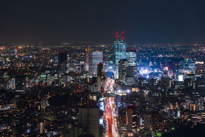 High angle view of city lit up at night