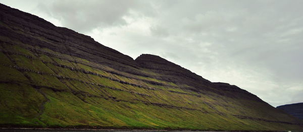 Scenic view of mountains against cloudy sky