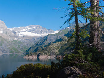 Scenic view of lac d emosson by mountains in winter