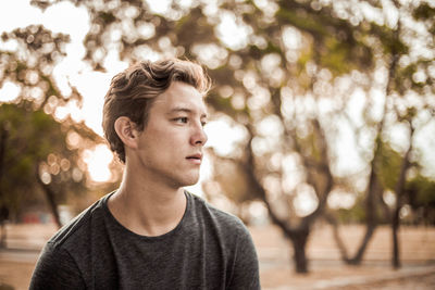 Close-up of thoughtful handsome young man looking away