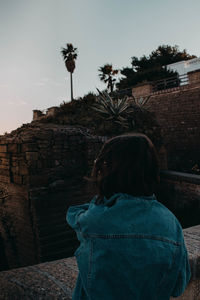 Rear view of woman looking at camera