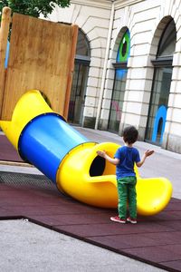 Full length of woman standing on slide