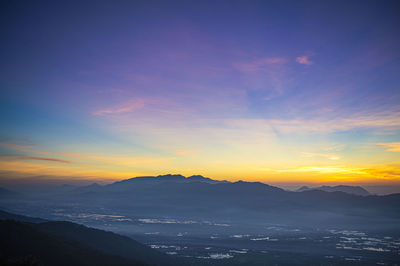 Scenic view of silhouette mountains against sky during sunset