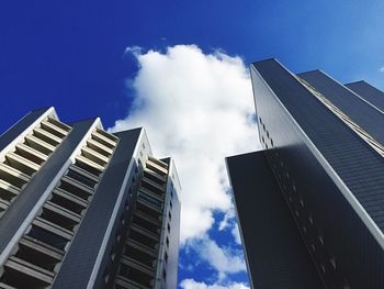 Low angle view of tall building against blue sky