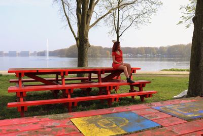 Woman sitting on bench in park