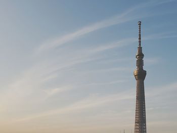 Low angle view of communications tower against sky