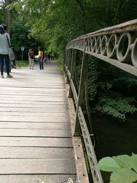 Woman walking on footbridge