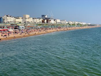 Scenic view of sea against buildings in city