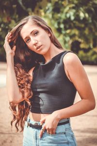 Portrait of beautiful woman with brown hair standing on street