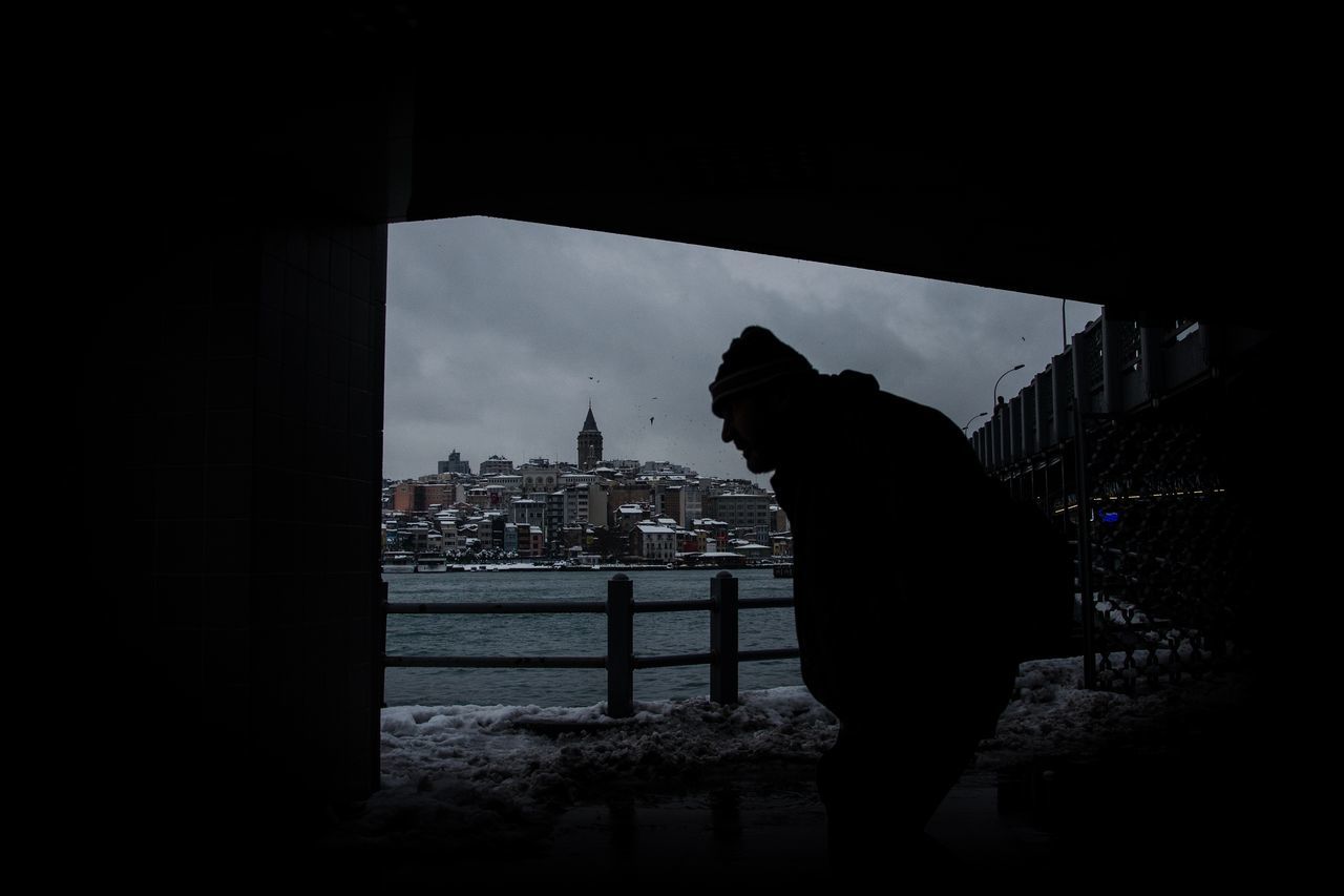 silhouette, city, architecture, river, travel destinations, building exterior, adults only, water, urban skyline, bridge - man made structure, only men, sky, one man only, cityscape, people, outdoors, night, one person, adult