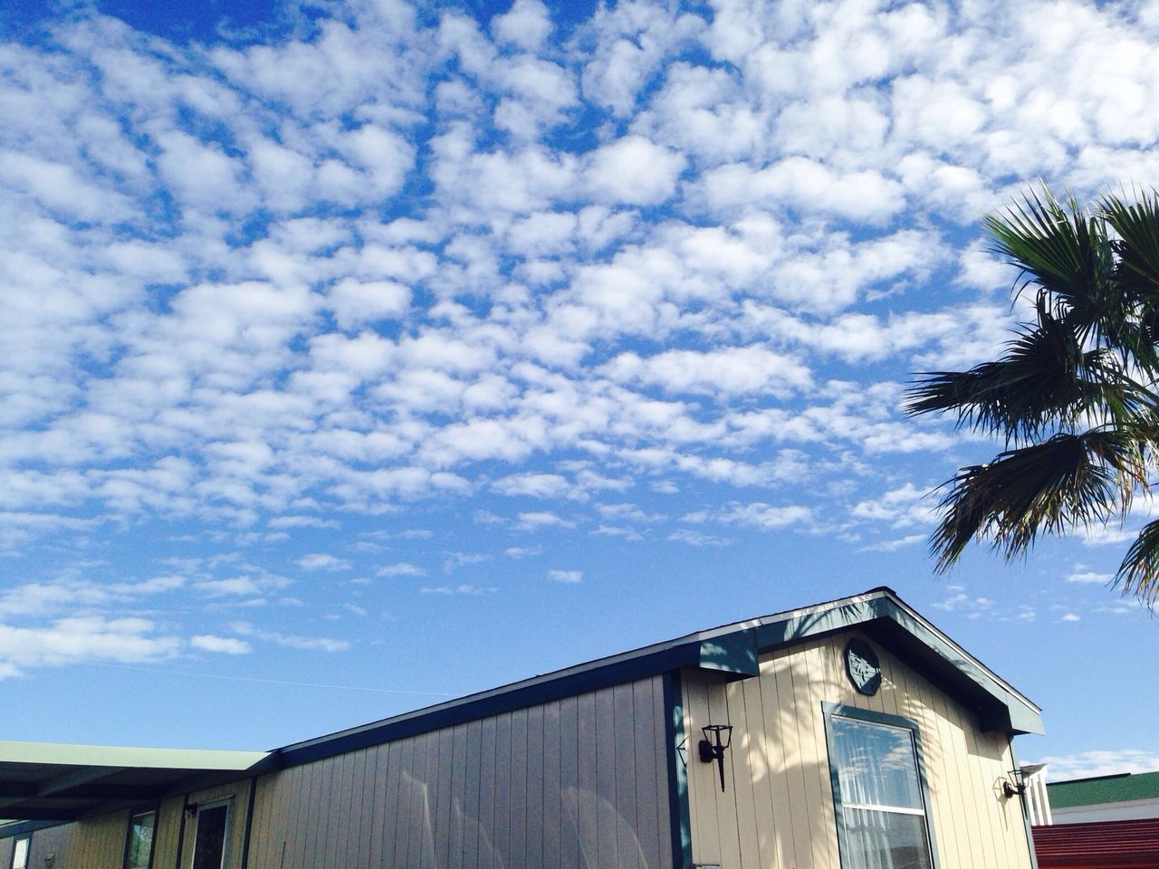 architecture, built structure, building exterior, sky, low angle view, house, residential structure, cloud - sky, residential building, cloud, roof, cloudy, building, high section, window, day, outdoors, blue, no people, balcony