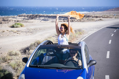 Portrait of young woman in car