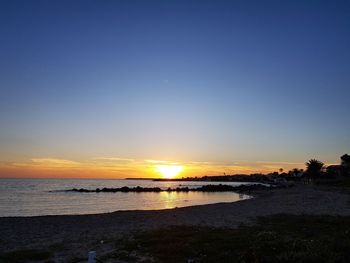 Scenic view of sea against clear sky during sunset