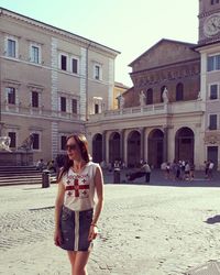 Full length of woman standing against building