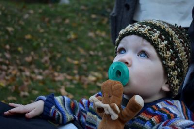 Cute boy with toy looking up