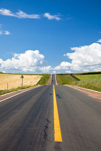 Road passing through landscape against sky