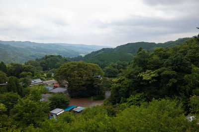 Scenic view of trees and mountains against sky