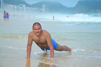 Happy shirtless man at beach