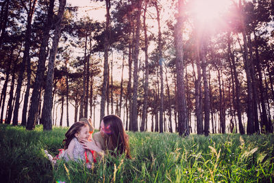 Mother and daughter in forest 