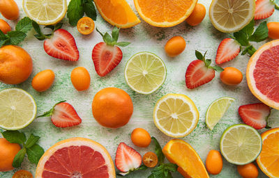 Fresh summer fruits on a green wooden background