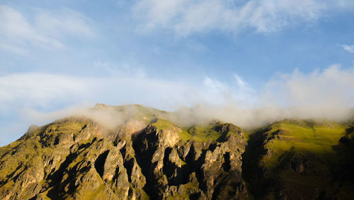 Scenic view of mountains against cloudy sky