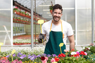 Young man working in greenhouse