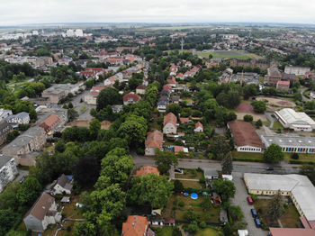 High angle view of trees and buildings in city