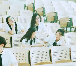 Students wearing uniforms while sitting in classroom