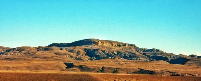 Scenic view of mountains against clear blue sky