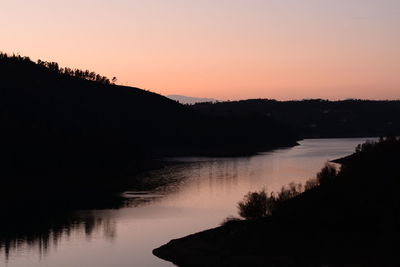 Scenic view of river against sky during sunset