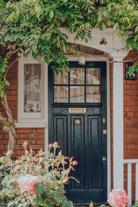 Black front door of a traditional edwardian house in london, uk, selective focus.