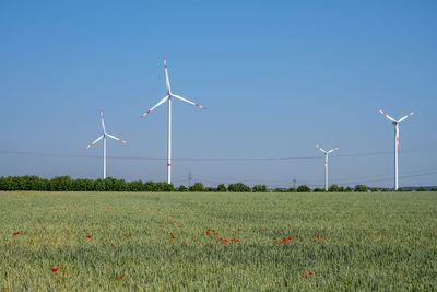 Wind energy turbines behind a cornfield in germany