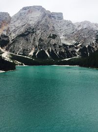 Scenic view of lake by mountains against sky