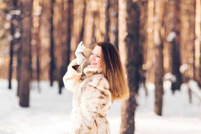 Woman standing on snow covered land