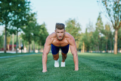 Low angle view of man exercising on field