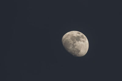 Low angle view of moon against clear sky at night