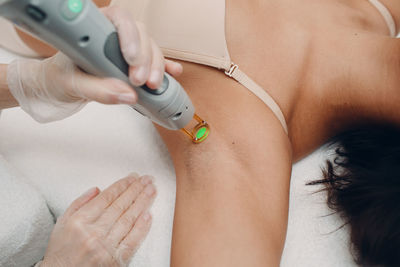 High angle view of woman getting treatment from doctor at hospital