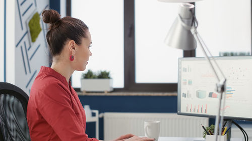 Side view of business colleagues working in office