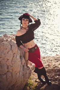 Portrait of a pirate woman at the beach. in anticipation of a pirate ship