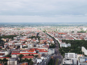 High angle view of townscape by sea against sky