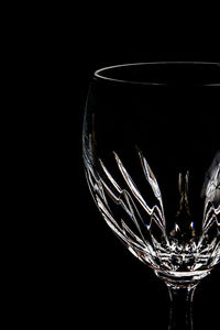 Close-up of wine glass against black background