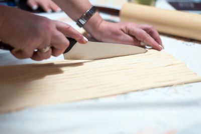 Close-up of woman holding hands on table