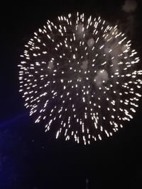 Low angle view of firework display at night