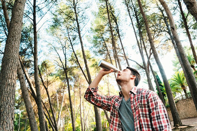 Young man standing in forest