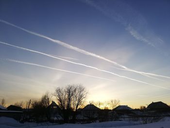 Scenic view of snow covered landscape against sky at sunset