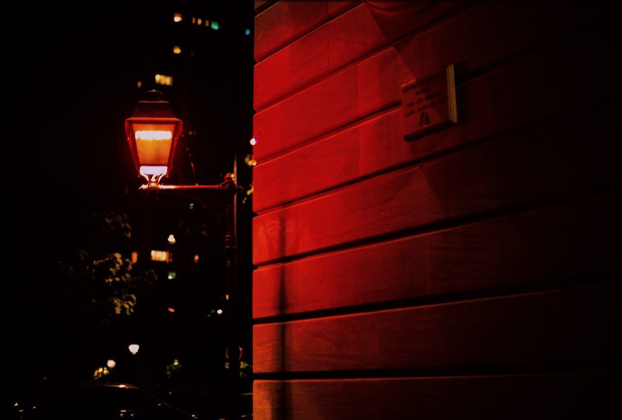 illuminated, architecture, night, building exterior, built structure, no people, city, building, lighting equipment, outdoors, street, dark, low angle view, red, light, residential district, transportation, glowing, electricity, wall - building feature