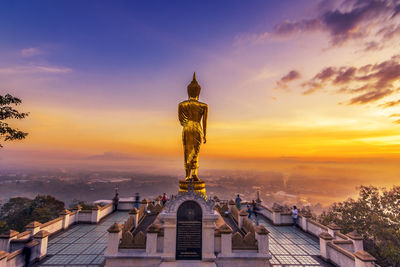 Statue of building against sky during sunset. khao noi temple, nan province, thailand