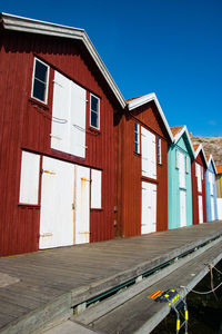Fisherman huts against clear blue sky