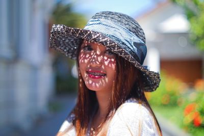 Portrait of young woman wearing hat