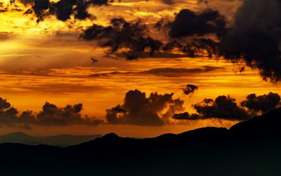 Scenic view of dramatic sky during sunset